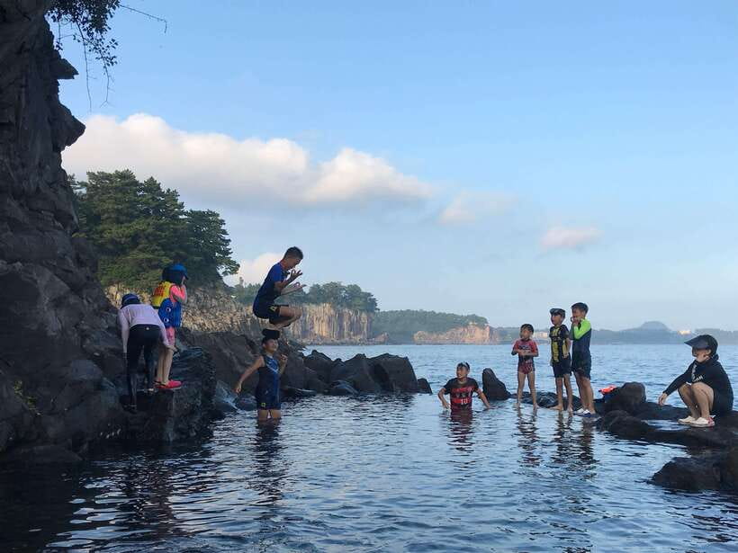 Jeju Island: Van Tour with a Guide Who Most Loves Jeju - Jeongbang Waterfall starts the day with a coastal jolt