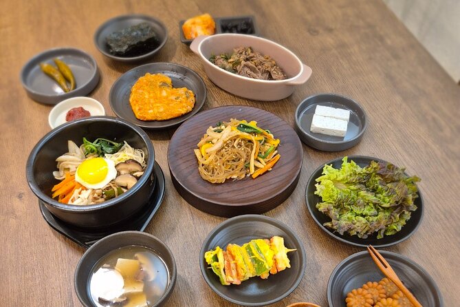 Traditional Korean 6-Dish Cooking Class + Hidden Alley Tour Seoul - Sitting down for a Korean family-style meal